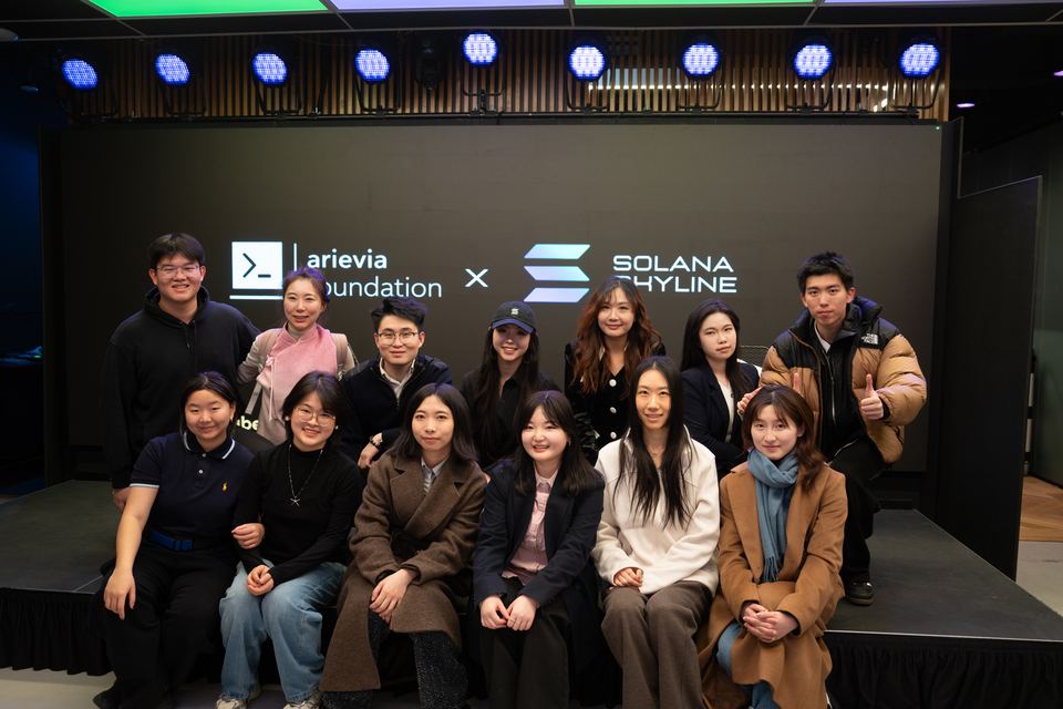 The Arievia team and volunteers in front of the stage