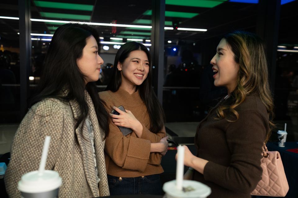 Attendees laughing together during the mingling hour