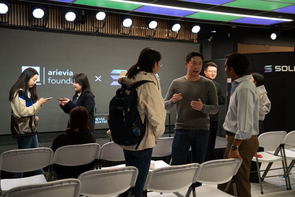 Attendees gathering near the stage after the program